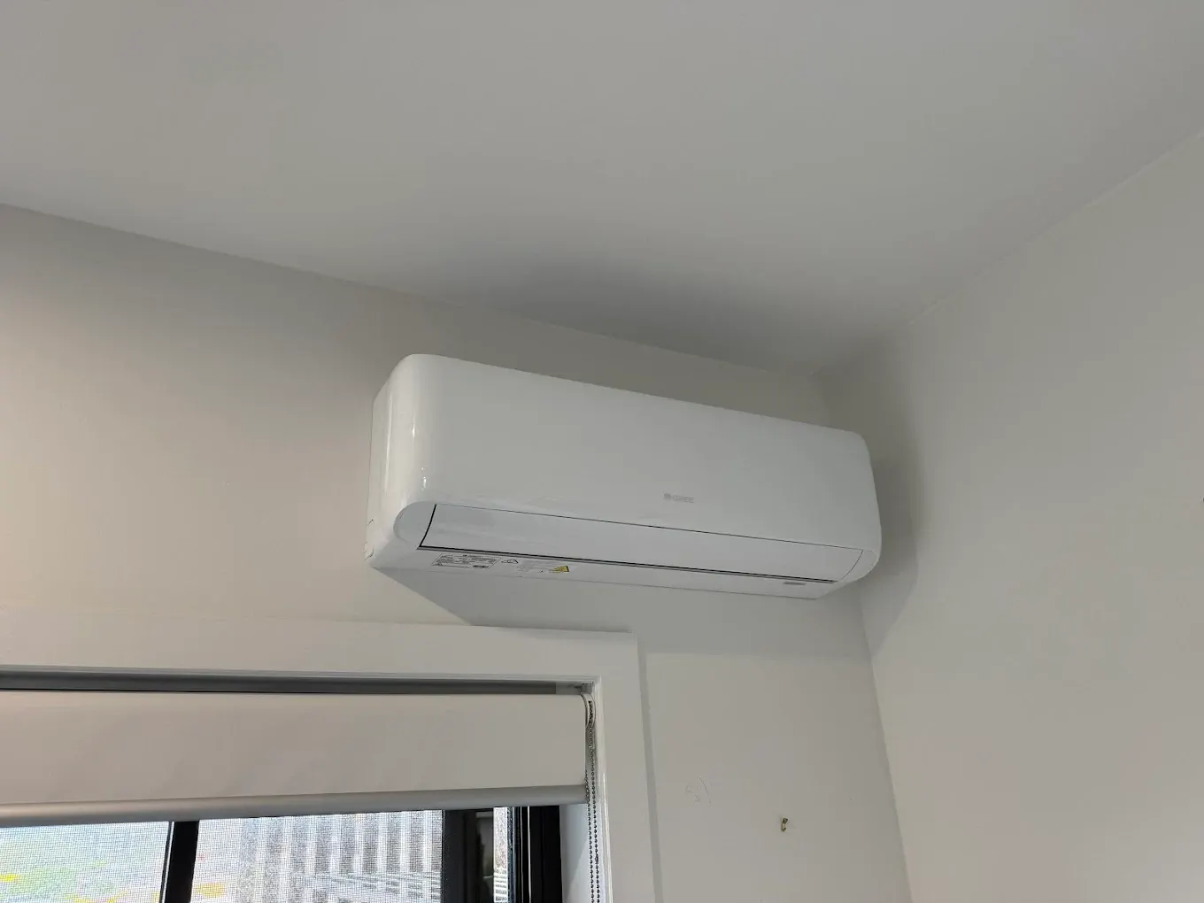 Refrigerant pipework run neatly along an exterior wall by Hart Air