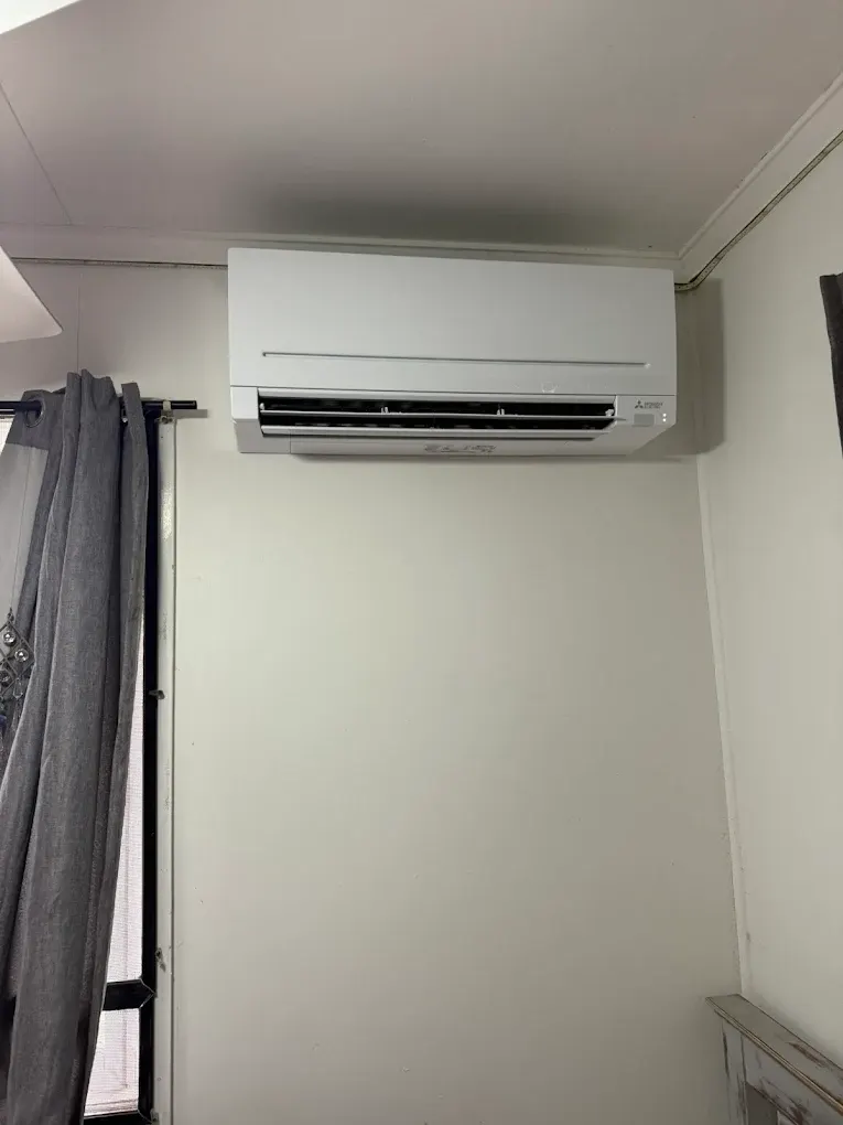 External wall-mounted condenser unit installed by Hart Air Brisbane